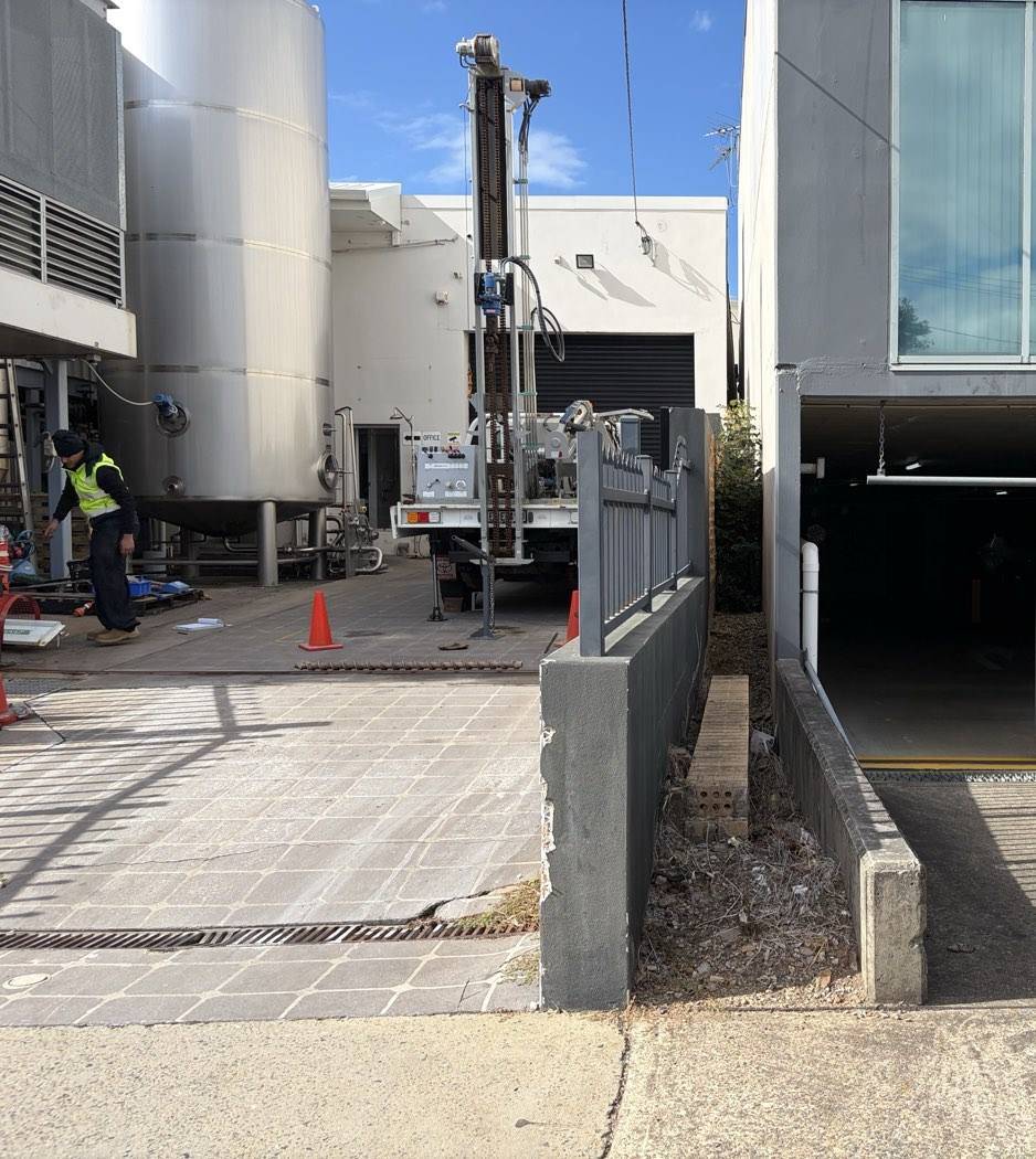 Borehole through the concrete yard of an operating Auburn factory