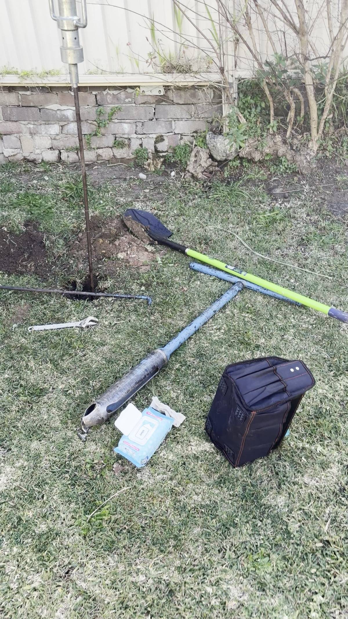 Hand-auger borehole investigation in a restricted-access Bexley North rear yard