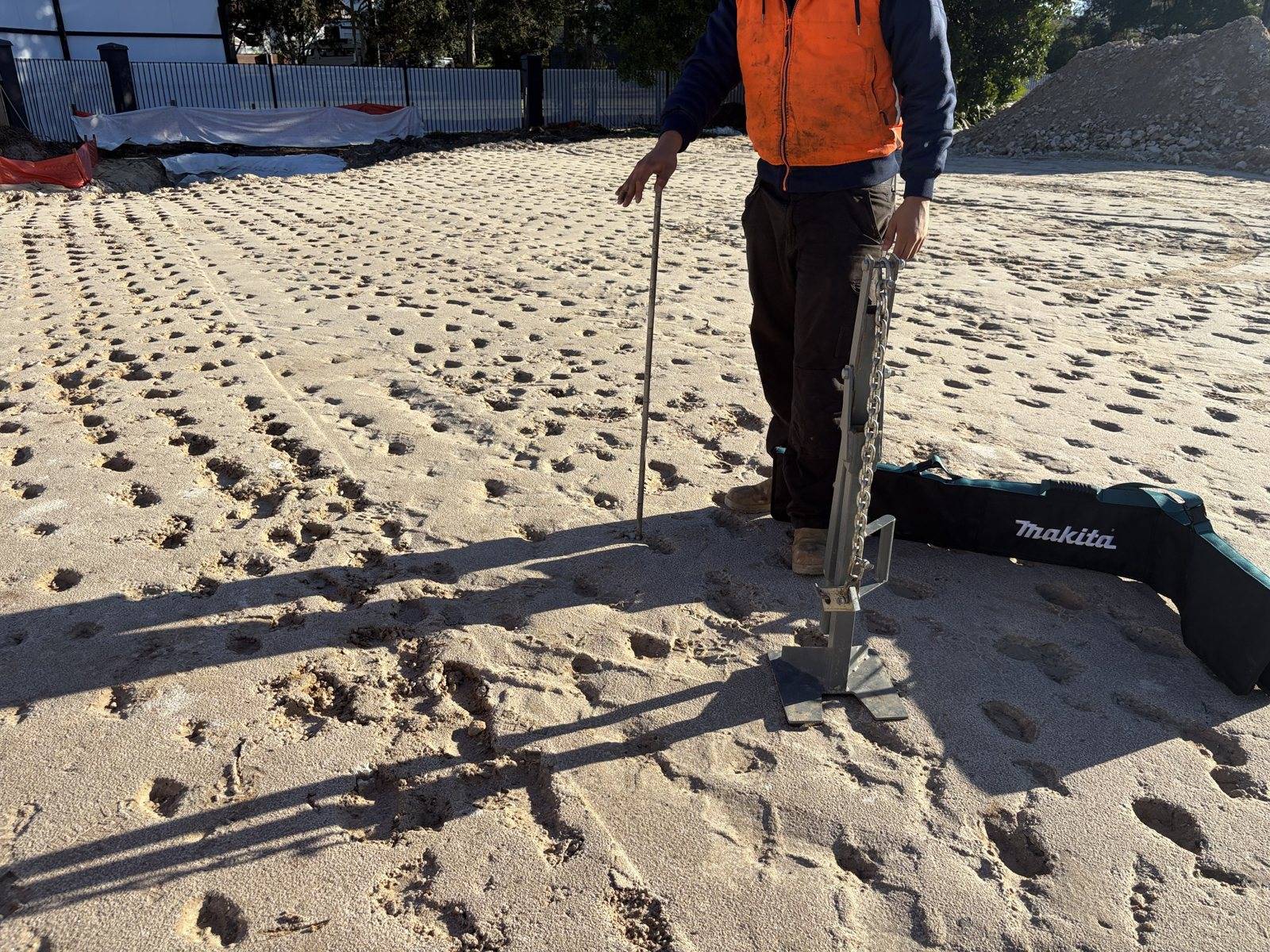 Dynamic cone penetrometer testing on a compacted pad at an industrial development