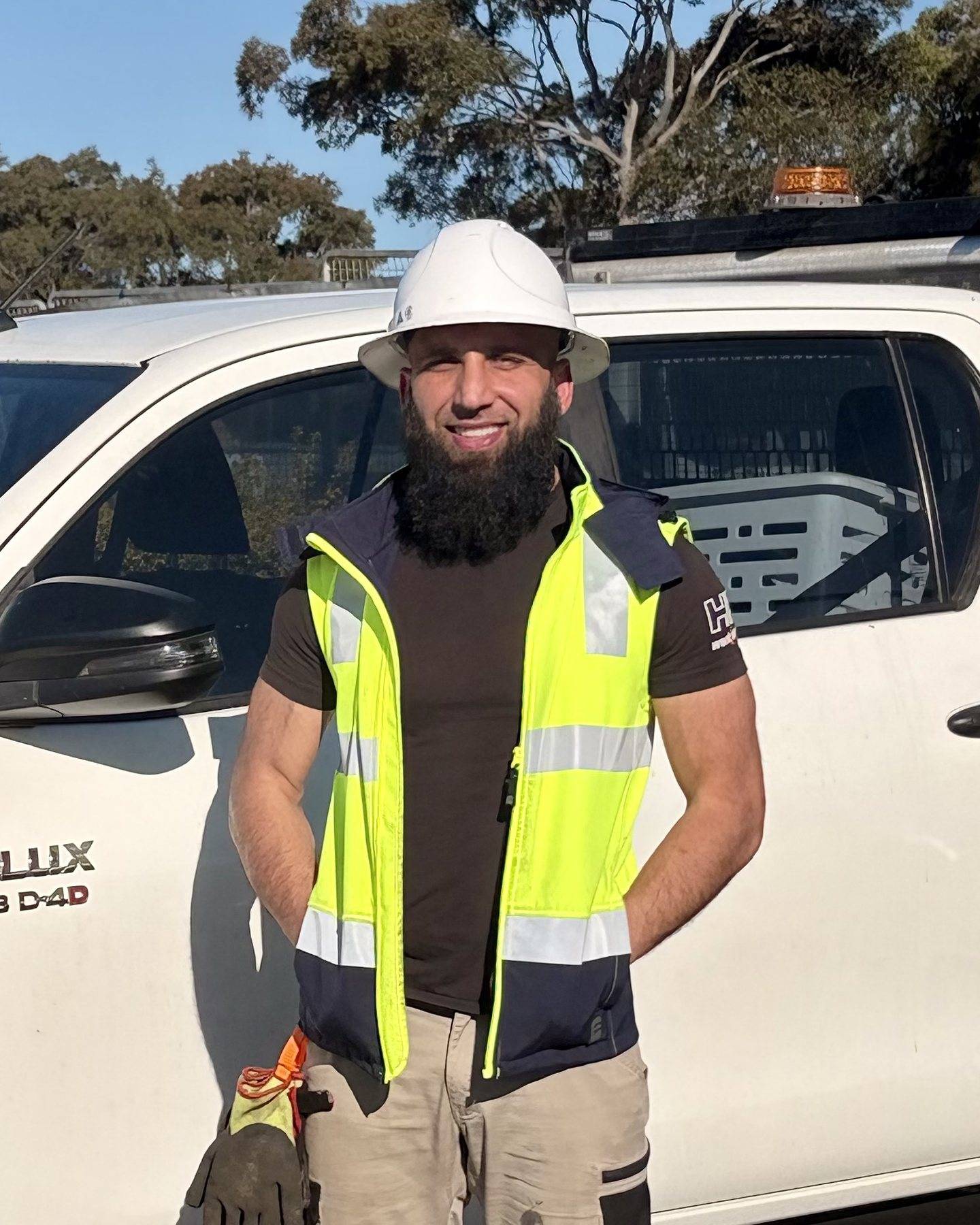SFGEO’s Principal Engineer in hard hat and hi-vis beside the site ute on a Sydney job