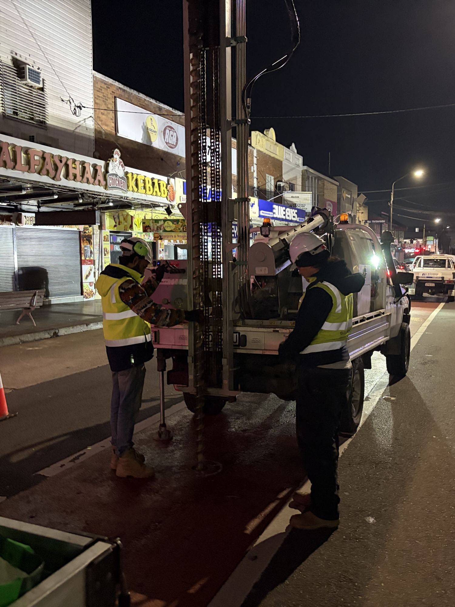 SFGEO engineers working the rig at a borehole during night works on a Sydney street